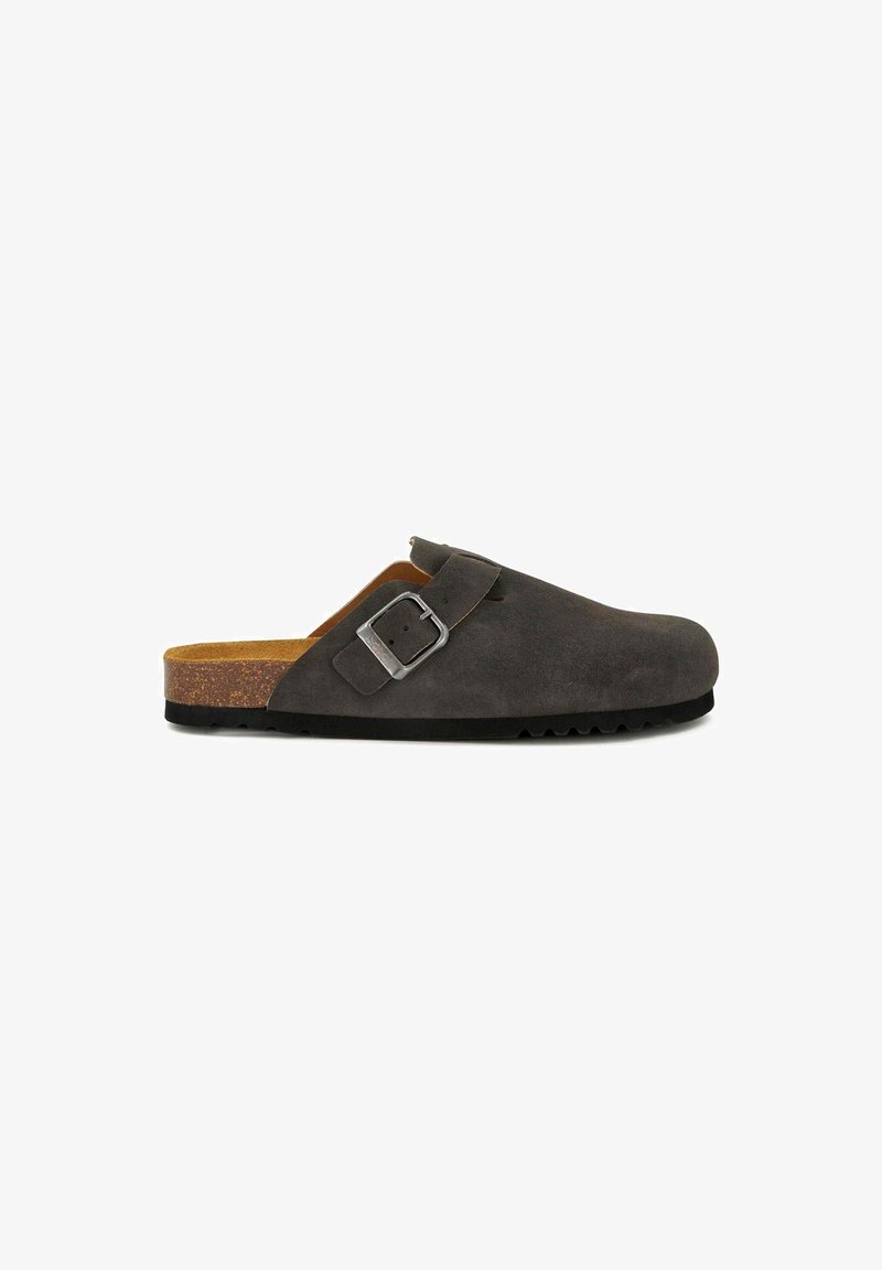 Grey suede slip-on clog with a rounded toe, adjustable metal buckle, cork footbed, and textured black rubber sole.