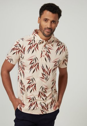 Polo de manga corta en crema con un estampado de hojas de bambú en rojo y azul marino. Presenta un cuello y una tapeta de tres botones, confeccionado en una tela suave.