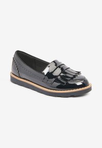 Black patent leather loafers with fringe detail, flat rubber sole, and decorative stitching along the sides.