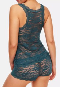 Teal lace sleep set with a loose-fit tank top and shorts, featuring floral patterns, scalloped edges, and semi-sheer texture.