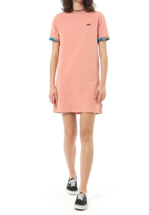 Person iført en lyserød Vans t-shirt kjole med ternet kant på ærmer og krave, kombineret med sort-hvide sneakers, stående på hvid baggrund.