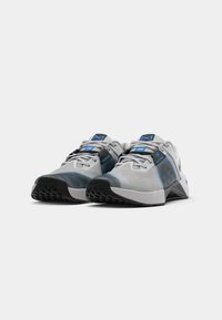 Gray and blue athletic shoes with black soles and laces, displayed side by side on a white background.