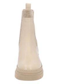 Botas de tobillo en beige con un exterior suave y acentos de fieltro en los laterales. Textura suave, suela de goma plana con borde elevado y costuras reforzadas.