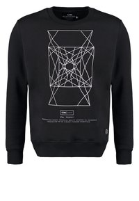 Sweatshirt noir avec un motif géométrique blanc, des poignets et un col côtelés, et une petite étiquette de marque sur le côté inférieur. Fabriqué en mélange de coton.