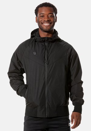 Black hooded jacket made of lightweight material with textured panels, elastic cuffs, and a zippered front. Features drawstring hood and logo.
