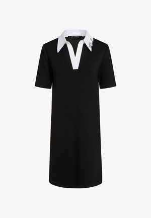 Juoda trumpa rankovė polo suknelė su balta apykakle, V formos iškirpte ir Karl Lagerfeld parašo detale ant apykaklės. Pagaminta iš minkštos medžiagos.