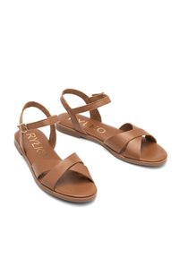Brązowe skórzane sandały z krzyżującymi się paskami, regulowanym paskiem na kostkę, płaską podeszwą oraz detalem z logo na wkładce.