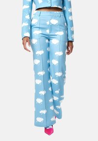 Light blue pants with white cloud patterns, tailored cut, high waist, and smooth fabric texture, paired with pink pointed heels.