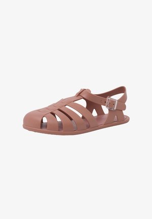 Brown rubber sandal featuring open straps, adjustable buckle, flat sole, and a rounded toe design with cutouts for ventilation.