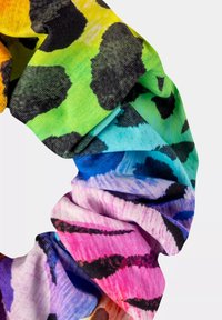 Kolorowa gumka do włosów z wyrazistym wzorem w panterkę w kolorach żółtym, zielonym, niebieskim, różowym i fioletowym. Wykonana z miękkiego, elastycznego materiału.