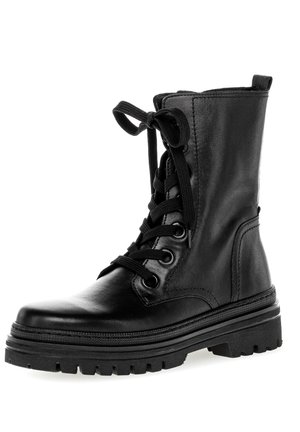 Black leather ankle boot with a rounded toe, front lacing, and a chunky rubber sole featuring deep tread for traction.