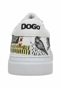 White sneaker featuring black "DOGO" logo, colorful bird illustrations, and abstract patterns on the heel. Rubber sole with textured grip.