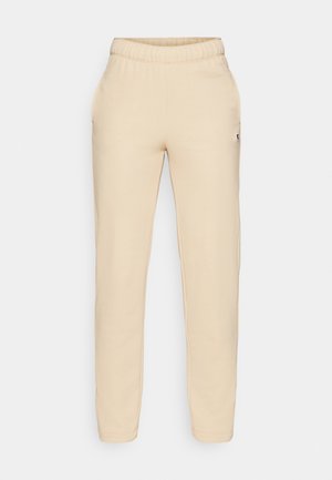 Beige bomuldsjoggerbukser med elastisk talje, sidelommer og et lille logo-patch på venstre ben. Glat tekstur og tætsiddende pasform.