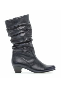Botte en cuir noir mi-mollet avec tige affaissée, talon carré bas, bout arrondi et languette de tirage sur fond blanc.