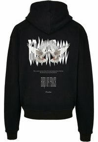 Černá mikina s kapucí, na které je grafika dvou bílých holubic, text "PTÁK MÍRU" a texturované písmo v kontrastní barvě.