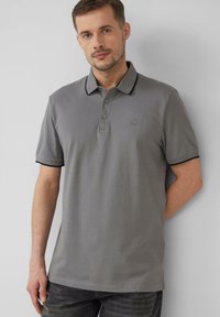 Grijze polo shirt van katoen, met een kraag, drie knoopsluiting en contrasterende zwarte accenten op de mouwen. Geborduurd logo detail.