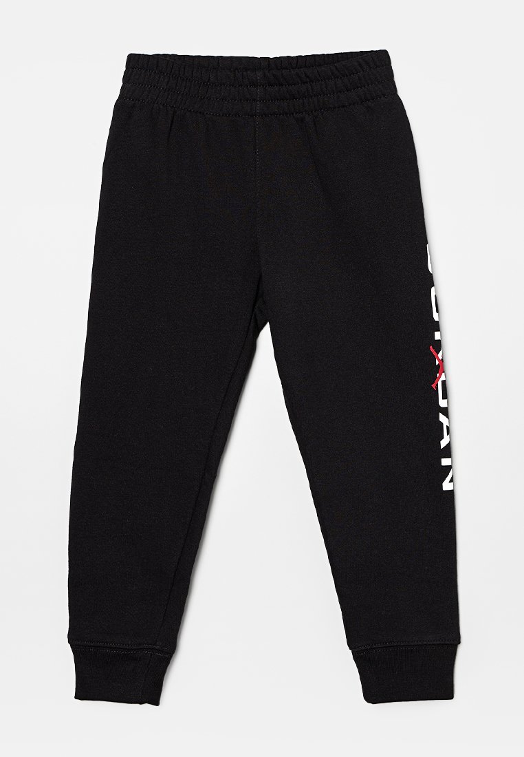 Black athletic pants with an elastic waistband, ribbed cuffs, and white text design on the left leg. Made from a soft, textured fabric.