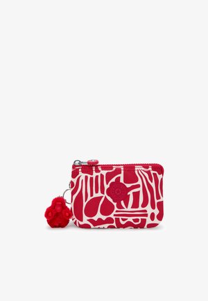 Red zippered wallet featuring a white abstract pattern. Includes a red pom-pom keychain detail and a round logo on the front.