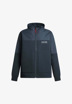 Tumši zils kapucēts jaka ar krāsu bloku dizainu. Iezīmēta ar priekšējo rāvējslēdzēju, divām lielām kabatām un Red Bull Racing logotipu uz krūtīm.