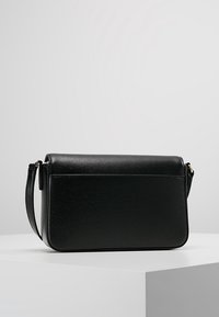 Black leather shoulder bag with a textured finish, rectangular shape, and a detachable strap. Simple design with no visible hardware details.