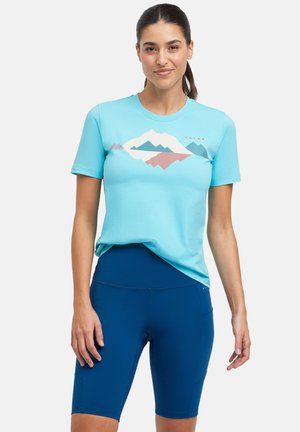 Light blue t-shirt with mountain graphic in white, teal, and coral, paired with navy blue bike shorts. Cotton blend fabric, short sleeves.