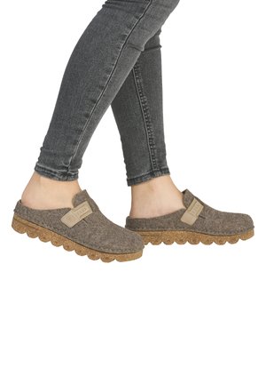 Gray felt clogs with a cork sole, featuring a tan accent strap and a scalloped edge. Textured material and open back design.