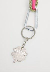 Keychain with a metal leaf-shaped charm featuring a textured pattern and "H2OFagerholt" engraved, attached to a silver carabiner and braided lanyard.