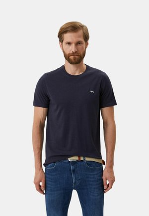 T-shirt in cotone blu navy con colletto rotondo, maniche corte e un piccolo logo ricamato sul lato sinistro del petto. Tessuto liscio.