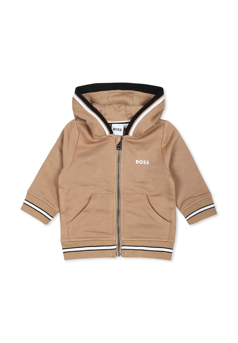 Haut à capuche zippé beige avec des accents rayés noirs et blancs, deux poches avant et une capuche. Présente le logo "BOSS" sur la poitrine.