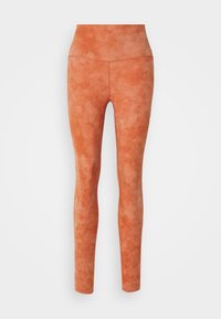 High-waisted, form-fitting leggings in a textured, muted orange fabric with a soft, brushed finish and elastic waistband.