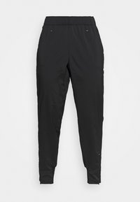 Czarne zwężające się spodnie sportowe z elastycznym paskiem w talii, bocznymi kieszeniami i zamkami błyskawicznymi na kostkach, przedstawione na białym tle.