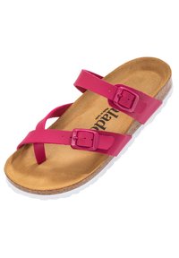 Pink sandal with two adjustable straps, buckle closures, and a cork footbed. White outsole with textured detailing. Flat profile.