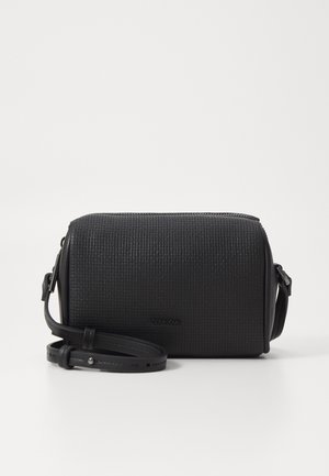 Black textured crossbody bag with a flat rectangular shape, featuring a zip closure and an adjustable strap. Logo embossed on the front.