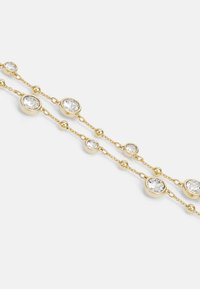 Gold-tone jewelry featuring clear round crystals in circular settings, interspersed with small gold orbs, on a delicate chain.