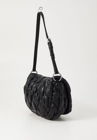 Black leather shoulder bag with padded quilted design, rounded shape, adjustable strap, and silver hardware accents.