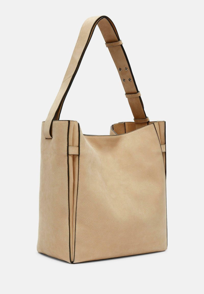 Beige Leder Tote-Bag mit strukturierter Form, ausgestattet mit einer glatten Textur und kontrastierenden dunklen Akzenten. Verstellbarer Schultergurt mit Hardware-Details.