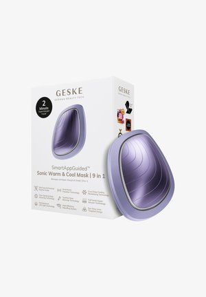 Appareil de masque facial incurvé violet à côté d'une boîte blanche étiquetée « SmartAppGuided Sonic Warm & Cool Mask 9 in 1 » avec des icônes technologiques.