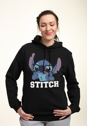 Black hoodie featuring a large print of a blue character with glasses and the word "STITCH" in bold white text at the bottom.