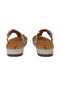 Sandali in pelle marrone con due cinturini regolabili, una soletta imbottita e una suola piatta bianca. Il design presenta uno stile minimalista.