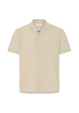 Bēša īsroku krekls ar pogām, nometamu apkakli un sešām baltām pogām, attēlots uz baltas fona.