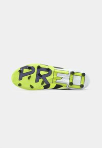 Football boot sole with bright yellow studs and the word "PREDATOR" in large black letters across the bottom.