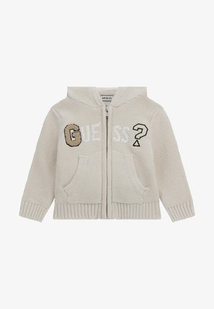 Beidzs zeķēts zip-up džemperis ar vārdu "GUESS" atšķirīgās tekstūrās, divām priekšējām kabatām un mīkstu, tekstētu apdari.
