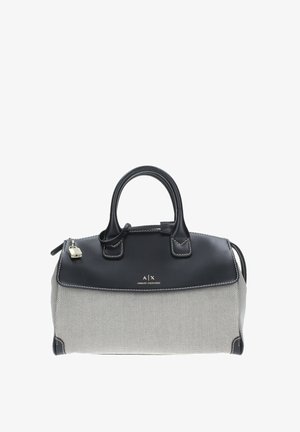 Borsa nera e crema con corpo texturizzato, dettagli in pelle liscia, doppi manici e chiusura con zip. Presenta dettagli del logo e cuciture.