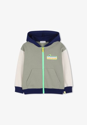 Veste à capuche zippée en vert, blanc et bleu marine. Dispose d'une fermeture éclair jaune néon et du texte « GO WITH THE FLOW » avec un motif de vague. Deux poches devant.