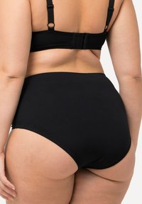 Black high-waisted underwear made of smooth fabric, featuring a seamless design and a comfortable elastic waistband. Back view shows fit.