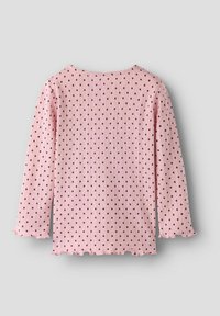 Jasnoróżowy prążkowany top z długimi rękawami, ozdobiony małymi brązowymi groszkami i falbankowymi wykończeniami. Prosty, okrągły dekolt.