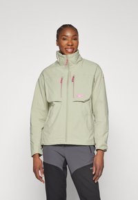 Veste zippée vert clair avec un col haut, ornée de détails de fermeture éclair rose et de deux poches avant. Fabrication en tissu doux et texturé.
