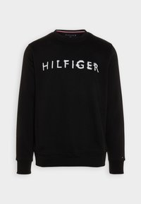 Černá mikina z bavlněné směsi, s kulatým výstřihem a žebrovanými manžetami. Bílé logo "HILFIGER" na přední straně v živém stylu.