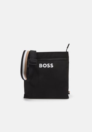 Black fabric bag with adjustable shoulder strap. Features a top zipper and white "BOSS" logo. Includes a striped accent in beige and white.