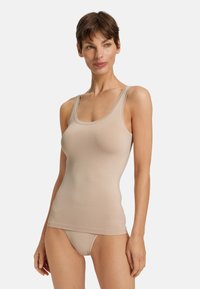 Světle béžový top bez rukávů s úzkým střihem a kulatým výstřihem. Vyrobeno z hladké, elastické tkaniny. Spárováno se shodným světlým spodním prádlem.